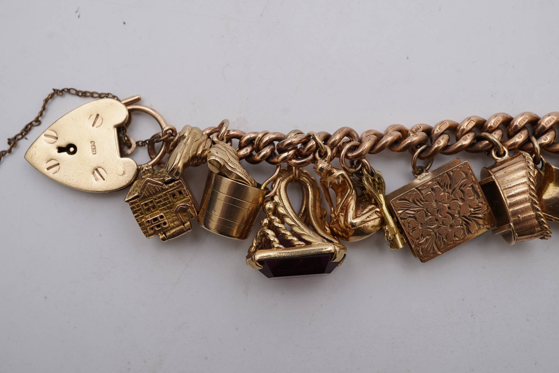 A 9ct gold charm bracelet, mid 20th century